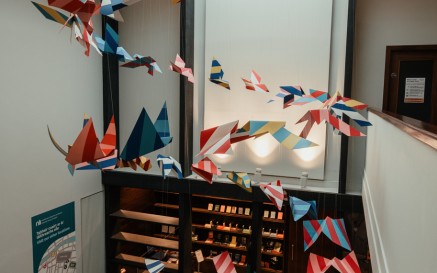 Paper bird decorations in the vestibule of the Seamus Heaney Listen Now Again Exhibition