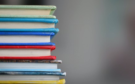 A stack of brightly coloured hardback books